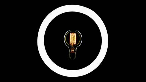 tungsten light bulb blinking over black background.