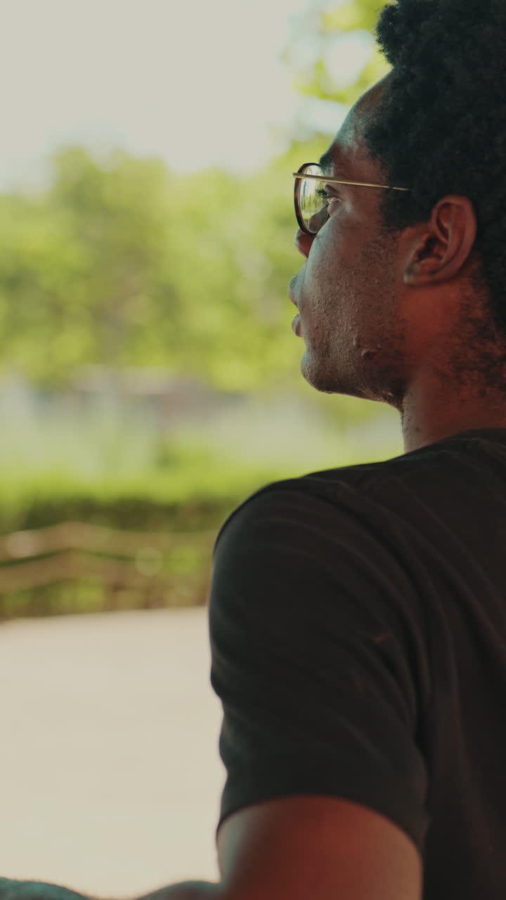 Young African American Man in Sunglasses Looking Away Outdoors