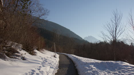lonely road with mountain ranges of the northern limestone alps during winter. dolly shot