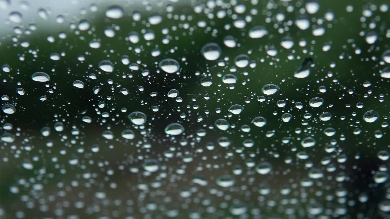 Close Up Footage Of Rain Drops Falling On Car Windscreen