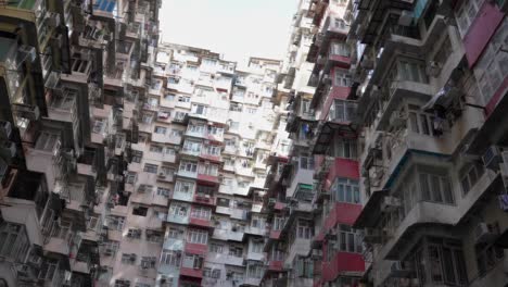 The-camera-reveals-an-overpopulated-housing-estate-Monster-Building-architectural-design,-Quarry-Bay,-Hong-Kong