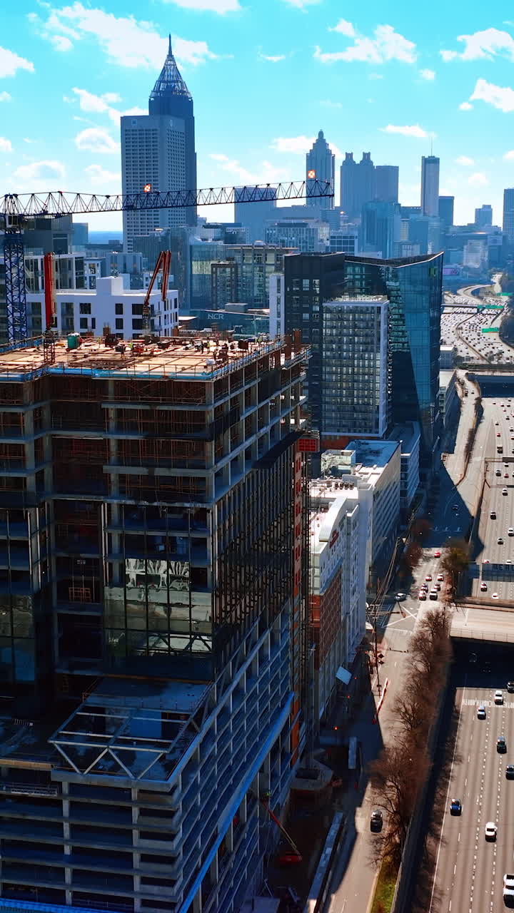 Lively traffic on the highways of Atlanta at daytime. Scenery of the city downtown from top on sunny fall day. Vertical video