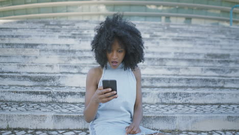 pretty woman googling on phone, looking surprised, saluting