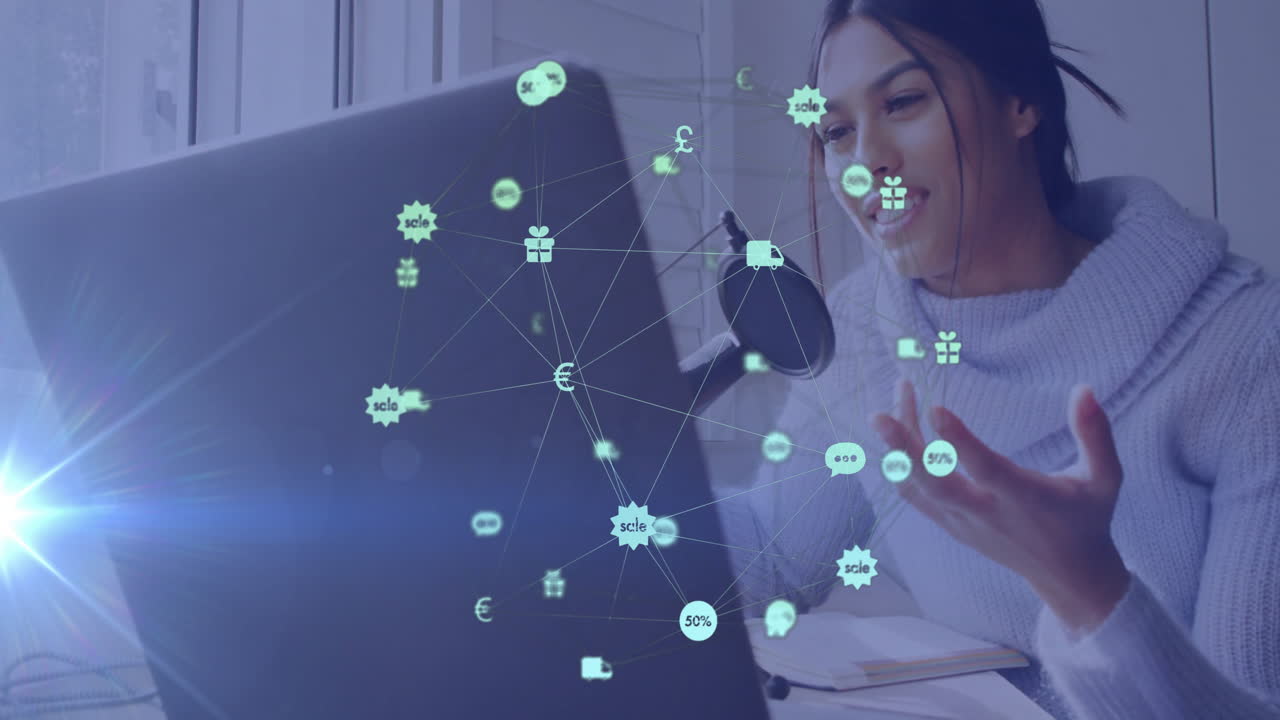 Interacting with digital animation of financial symbols, woman using laptop at home