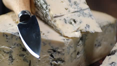 brie cheese with a knife rotates slowly on the table.