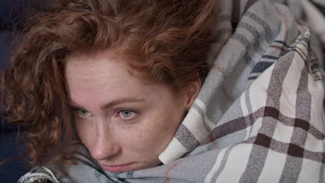 depressed young caucasian woman lying on sofa