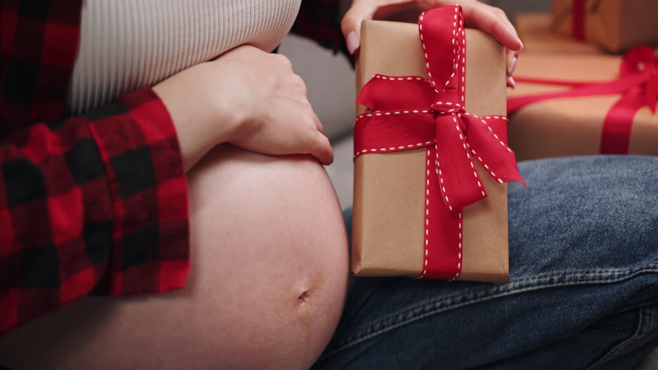 Pregnant woman with christmas gift