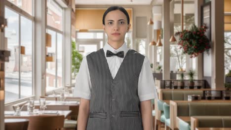 serious indian woman waiter looking