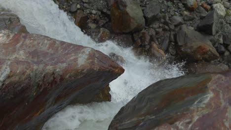 closeup shot of water flowing through rocks, water erosion, slow motion