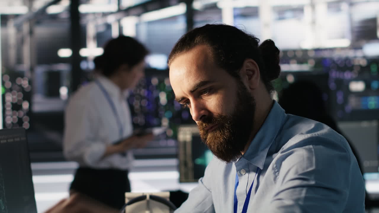 Vertical video Engineer in data center reorganizing desk items to boost productivity