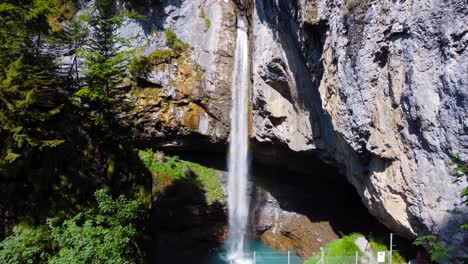 aerial shot approaching berglistüber waterfall in switzerland