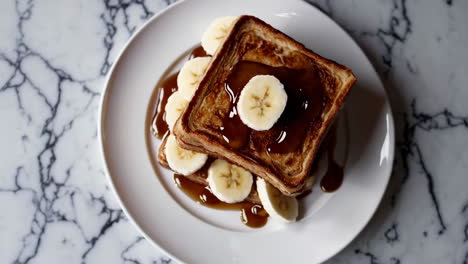 delicious stacked french toast with bananas and maple syrup