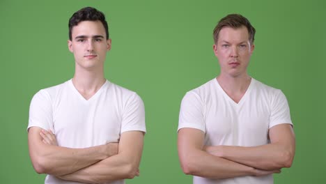 two young handsome men with arms crossed together