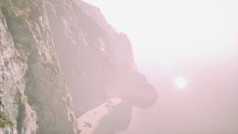 foggy coastline with mountain cliffs