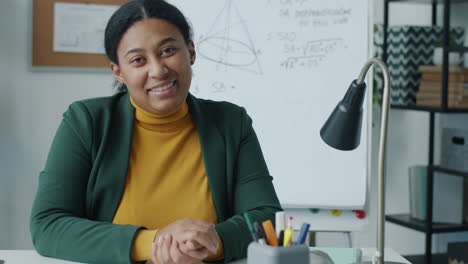 smiling teacher in classroom