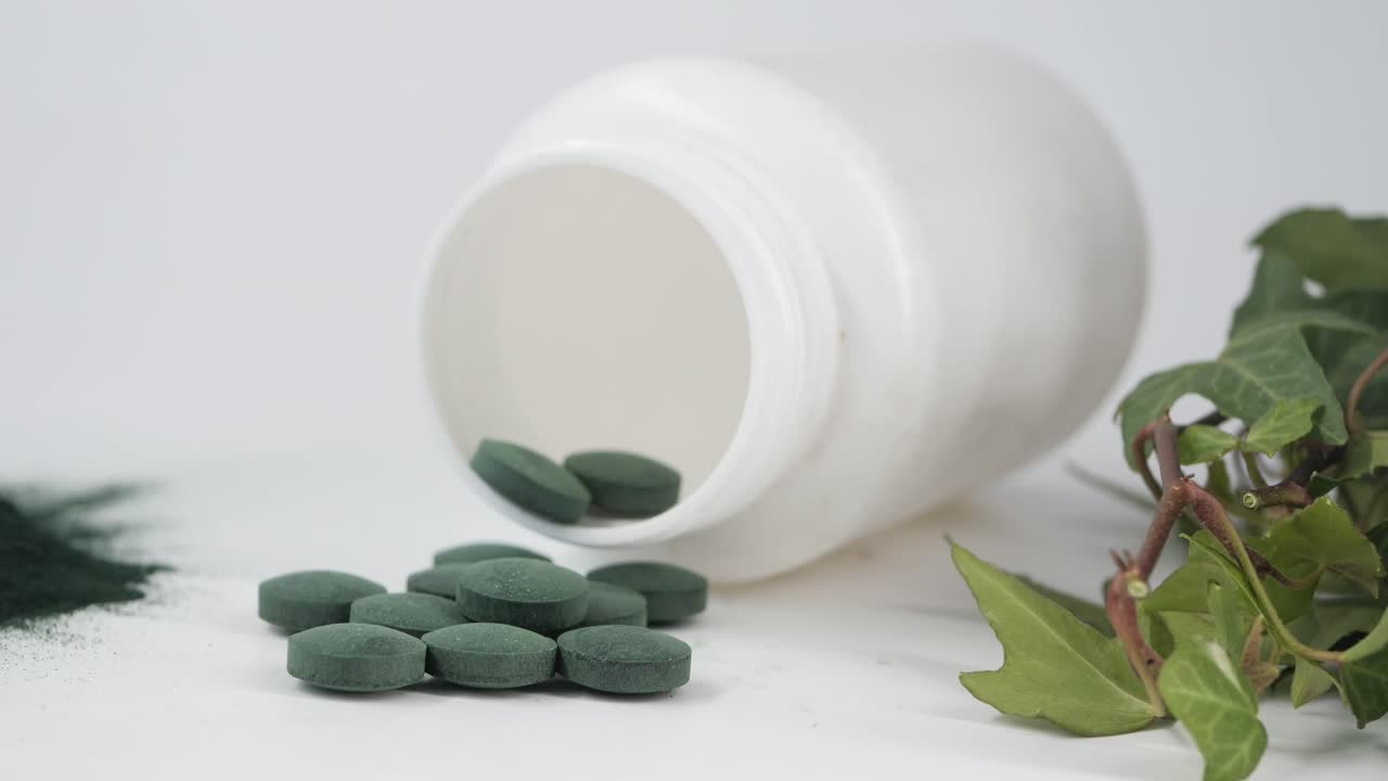 Green Spirulina Pills and Powder with Supplement Bottle