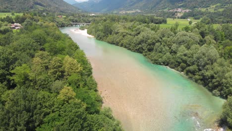 Aerial-view-rising-over-turquoise-river-valley-rural-forest-treetop-wilderness-scene