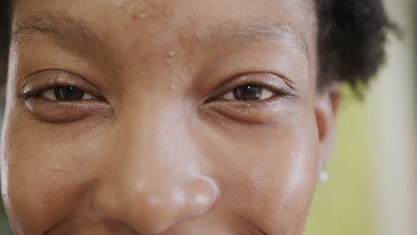 Portrait-close-up-of-eyes-of-happy-african-american-businesswoman-in-office,-in-slow-motion