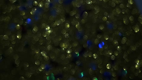 abstract background with rotating and shimmering dark green bokeh in the shape of a circle. abstract glowing circles. defocused effect