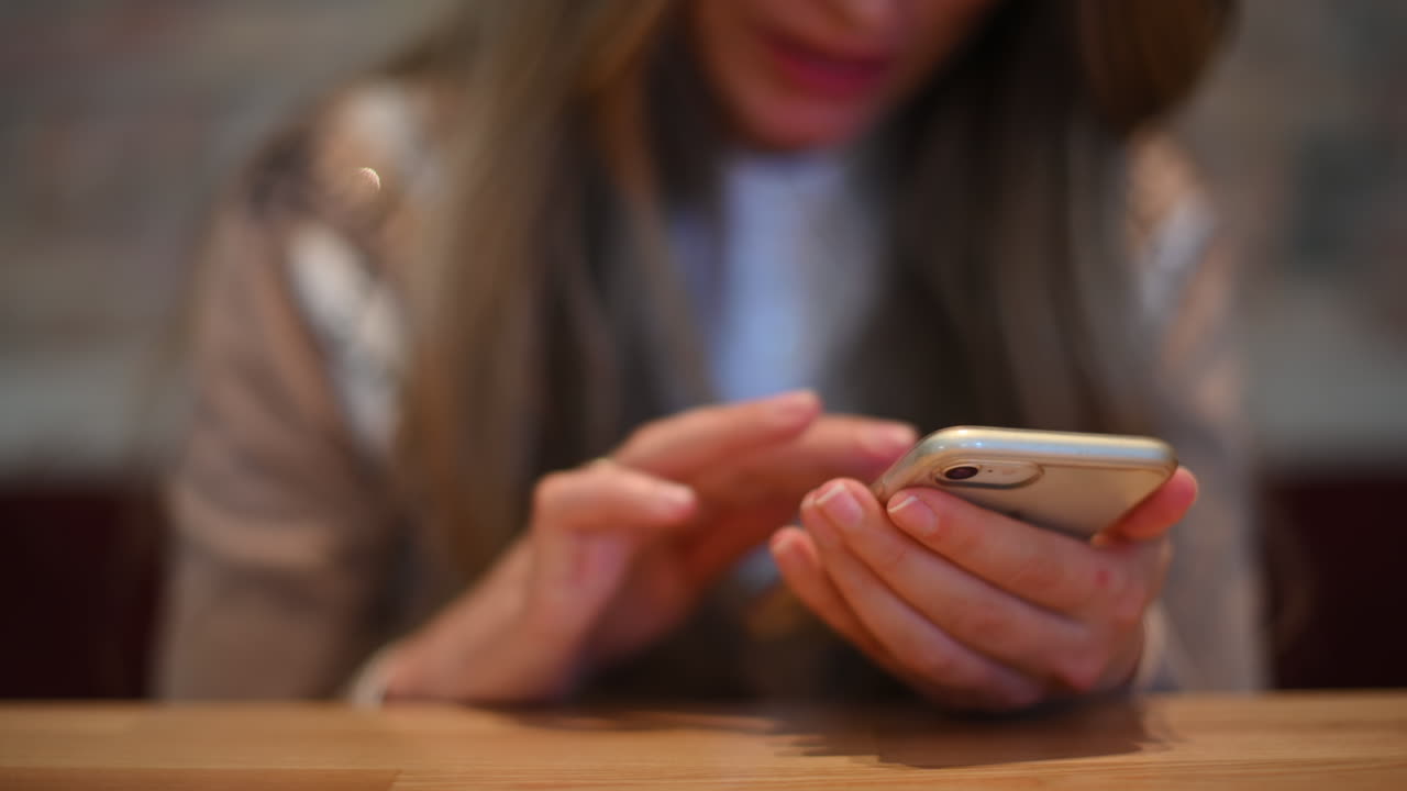 Woman working on mobile phone in a restaurant