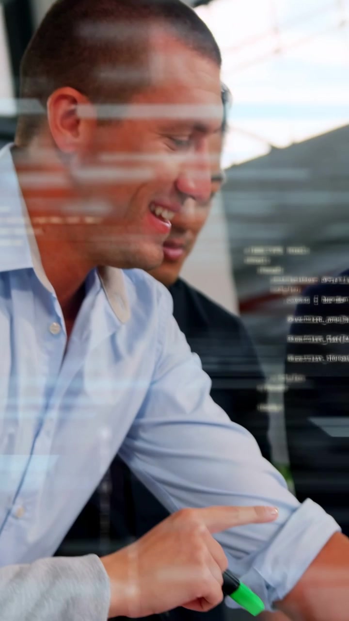 Vertical video: Designers leaning marking plans with green highlighter, code overlay aiding review