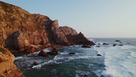 coastal cliffs and lighthouse at sunset