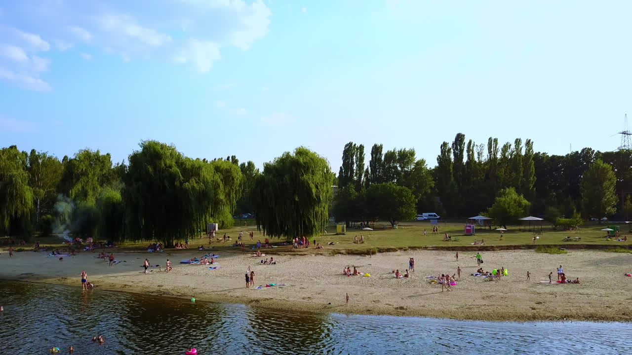 Riverbank Beach Scene with People
