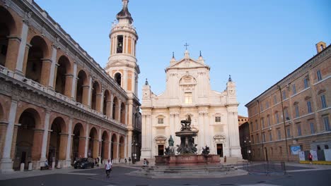 front view of santuario della santa casa and fountain in piazza della madonna, loreto