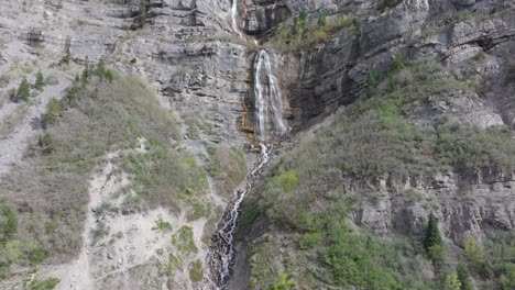 Aerial-pullback-of-Bridal-Veil-Falls-in-American-Fork-Canyon,-Utah-during-spring