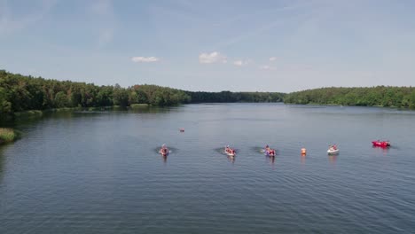 dragon boats racing on a lake, front view, drone shot