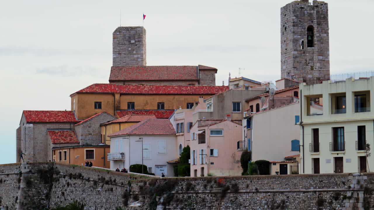 Antibes, France - February 20, 2025: View of people walking near different buildings on the coast