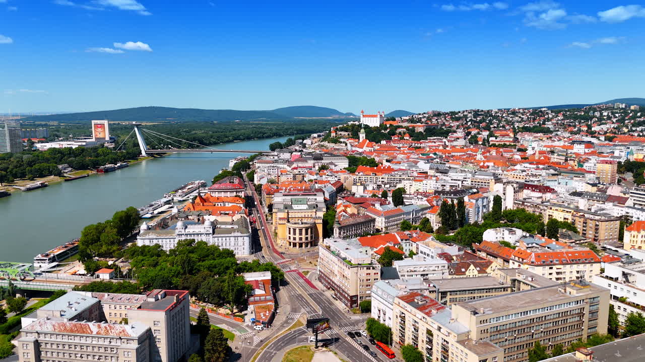 Aerial view of Bratislava old town and the Danube River. The historic red-roofed old town of Bratislava stretches along the Danube River