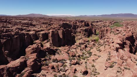 Flyover:-Hidden-green-valley-in-rugged-Valle-de-las-Rocas-landscape