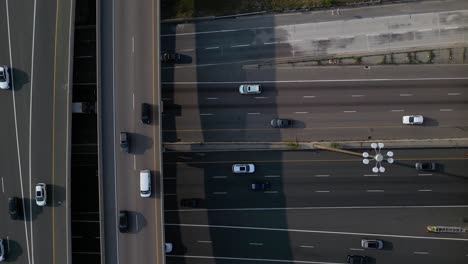 cars driving on modern highway infrastructure with multiple roadways and interchanges