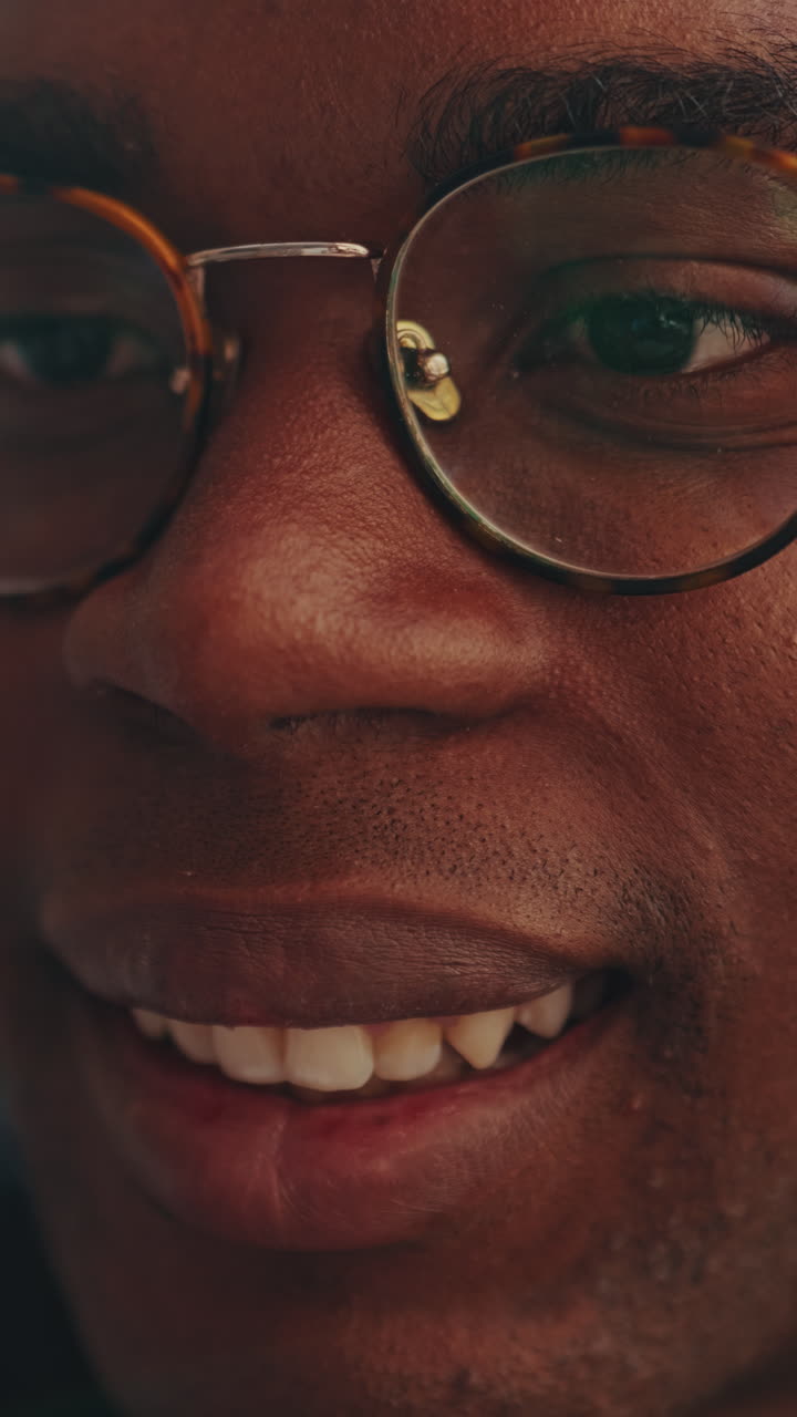 Close-up of a Smiling Young Black Man in Glasses