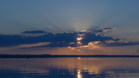 sunset over a lake with clouds