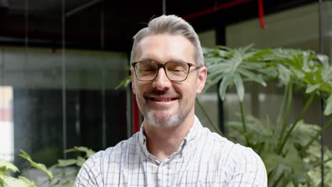 Portrait-of-caucasian-man-smiling-in-the-balcony-at-office