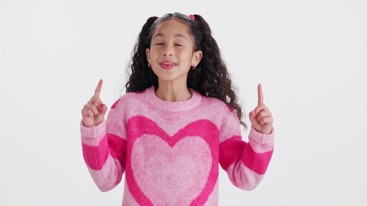 A happy girl pointing upwards