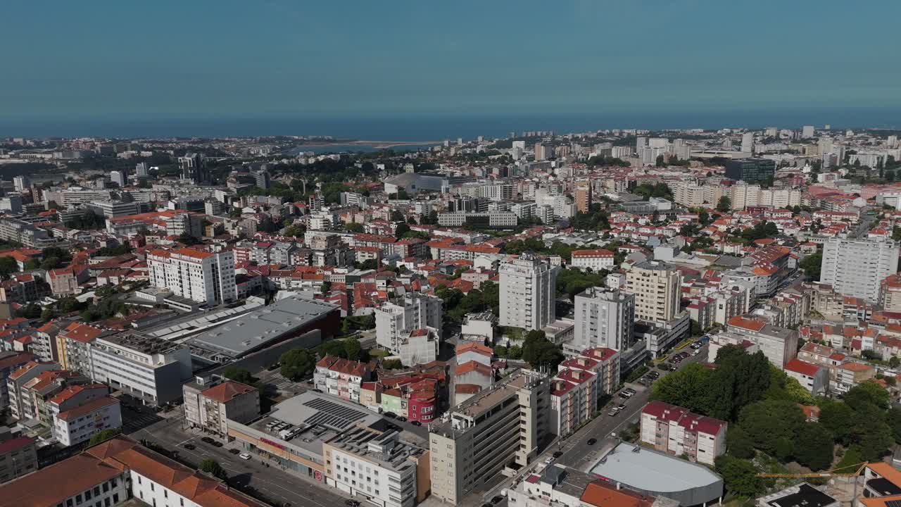 aerial shot of a busy street intersection in porto portugal with buildings and cars under sunlight