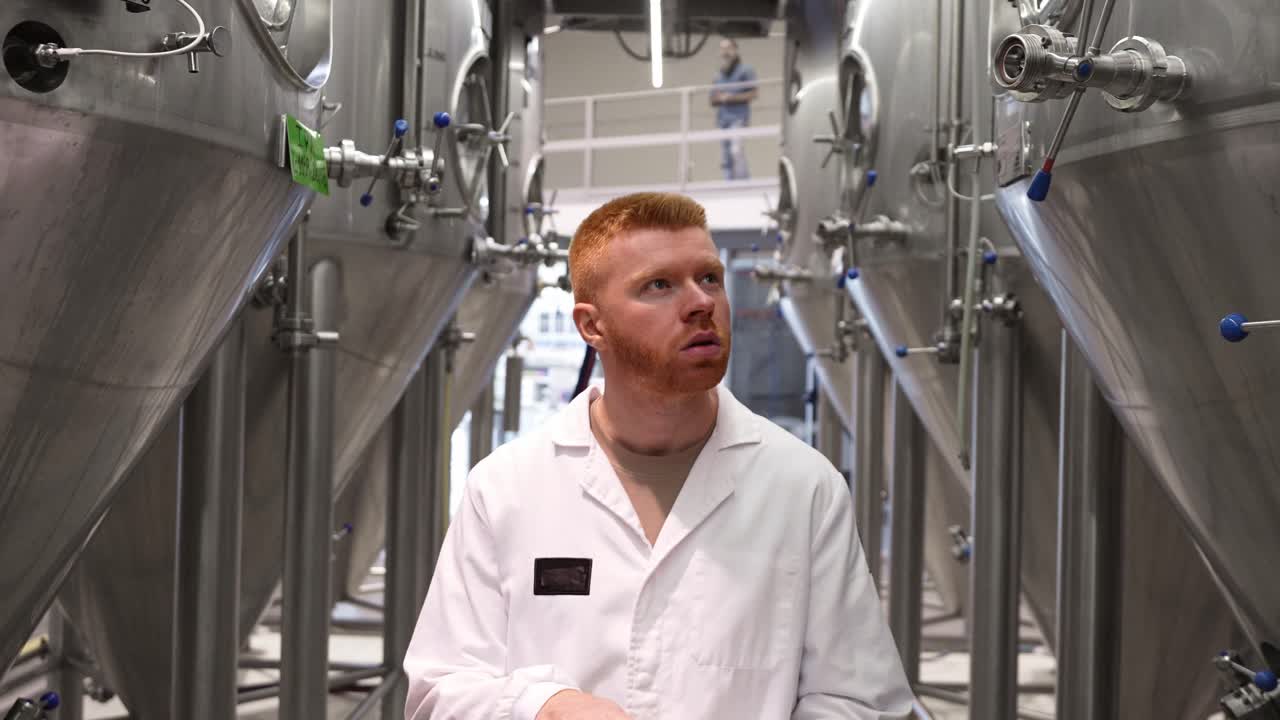Brewery Worker Inspecting Tanks