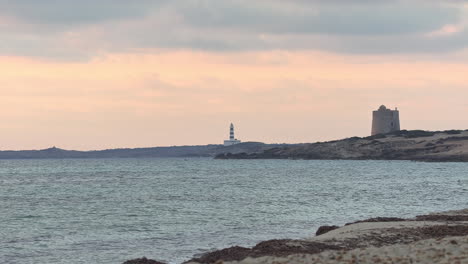 lighthouse and small fortress on a peninsula in ibiza