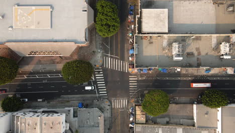 aerial view of an urban street intersection with buildings and vehicles
