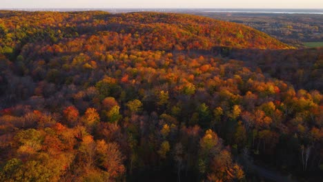 aerial panning view of the hills of gatineau park and the ottawa valley at sunset in autumn