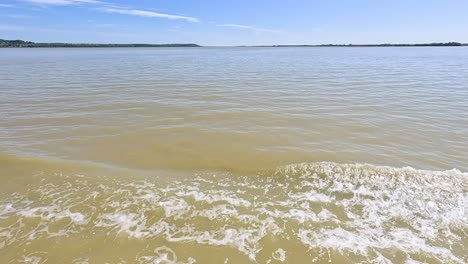 boat creates splashes on calm blaye waters