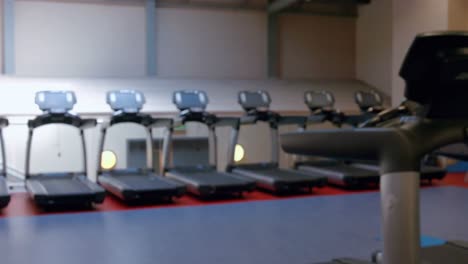 fit woman using exercise bike in gym