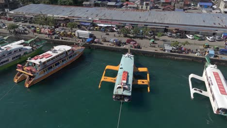 boats ready to take tourists on day trips are docked along surigao city boulevard on a bright day