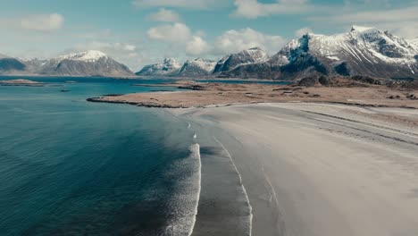 calm waves of yttersand beach near roren-ytresandheia mountain hike in lofoten islands, norway. aerial shot