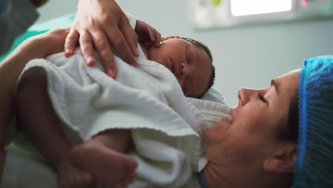 close-up of caucasian couple holding their newborn baby in operation theater