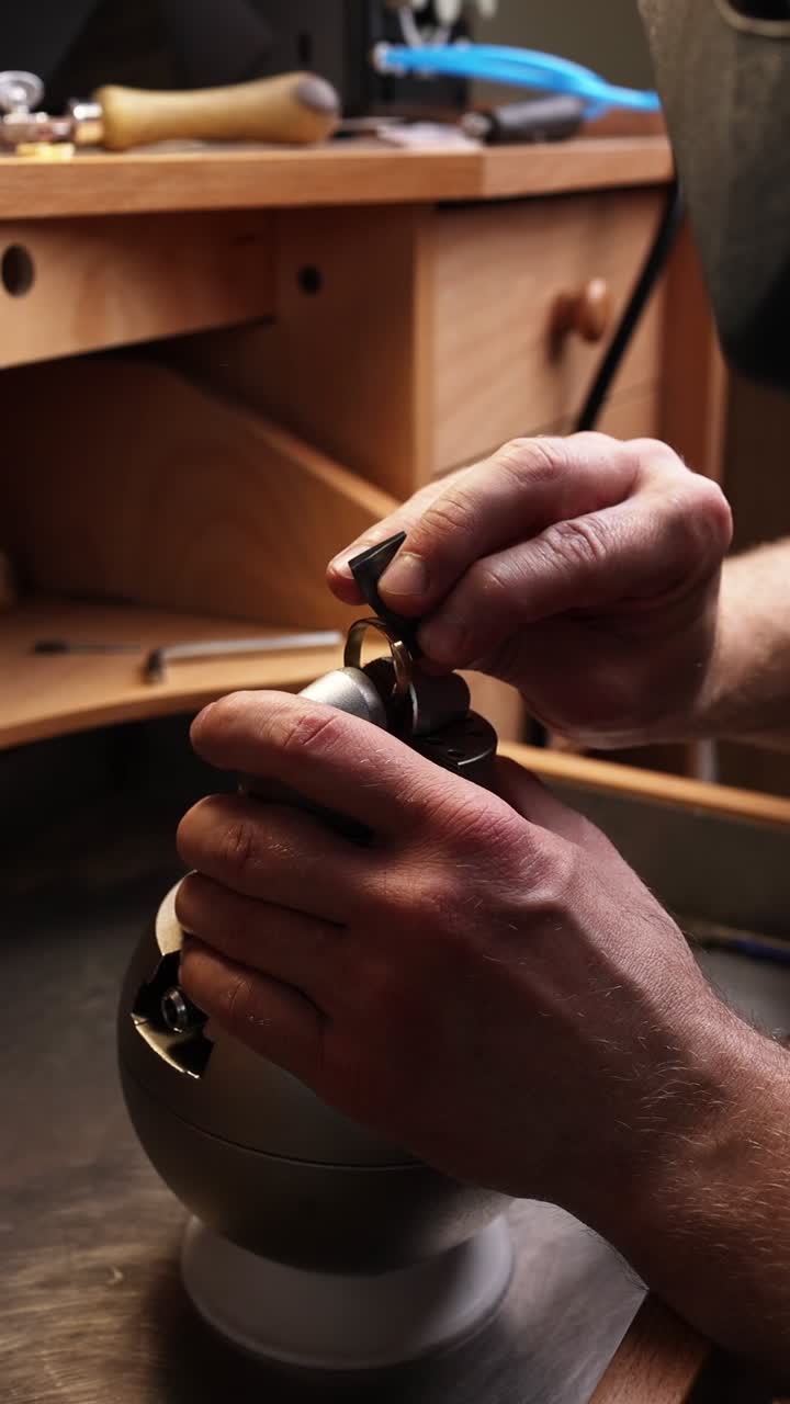 Close-Up of Jeweler's Hands Polishing a Ring in a Workshop