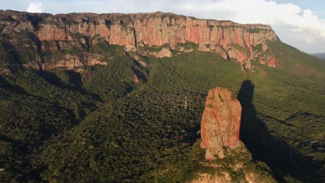 Golden-hour-aerial-orbits-Tower-of-David-rock-spire-in-Bolivia,-nature